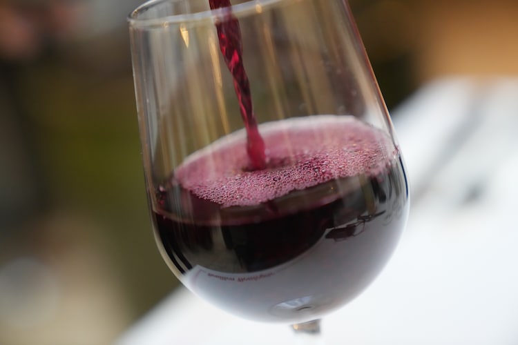 A glass of wine served at a restaurant outside Paris, France. (Photo by AP)